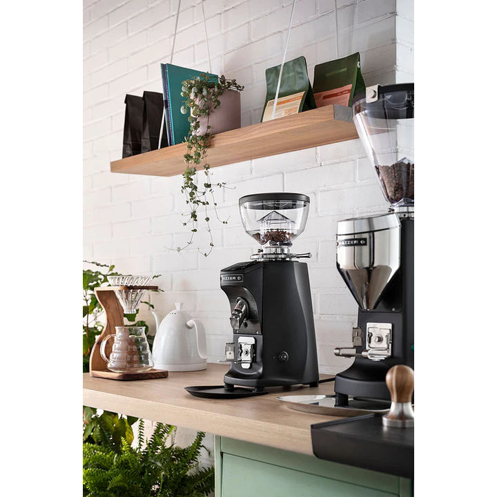 Black Mazzer Mini Compact espresso grinder on café bar