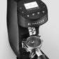 Black Mazzer Mini Grind by Weight espresso grinder with calibration weight inside portafilter