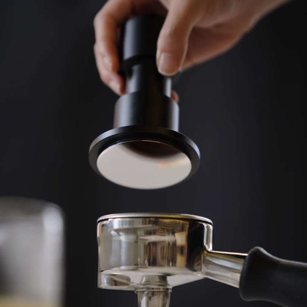 Timemore Impulse Impact spring loaded tamper being used with a portafilter